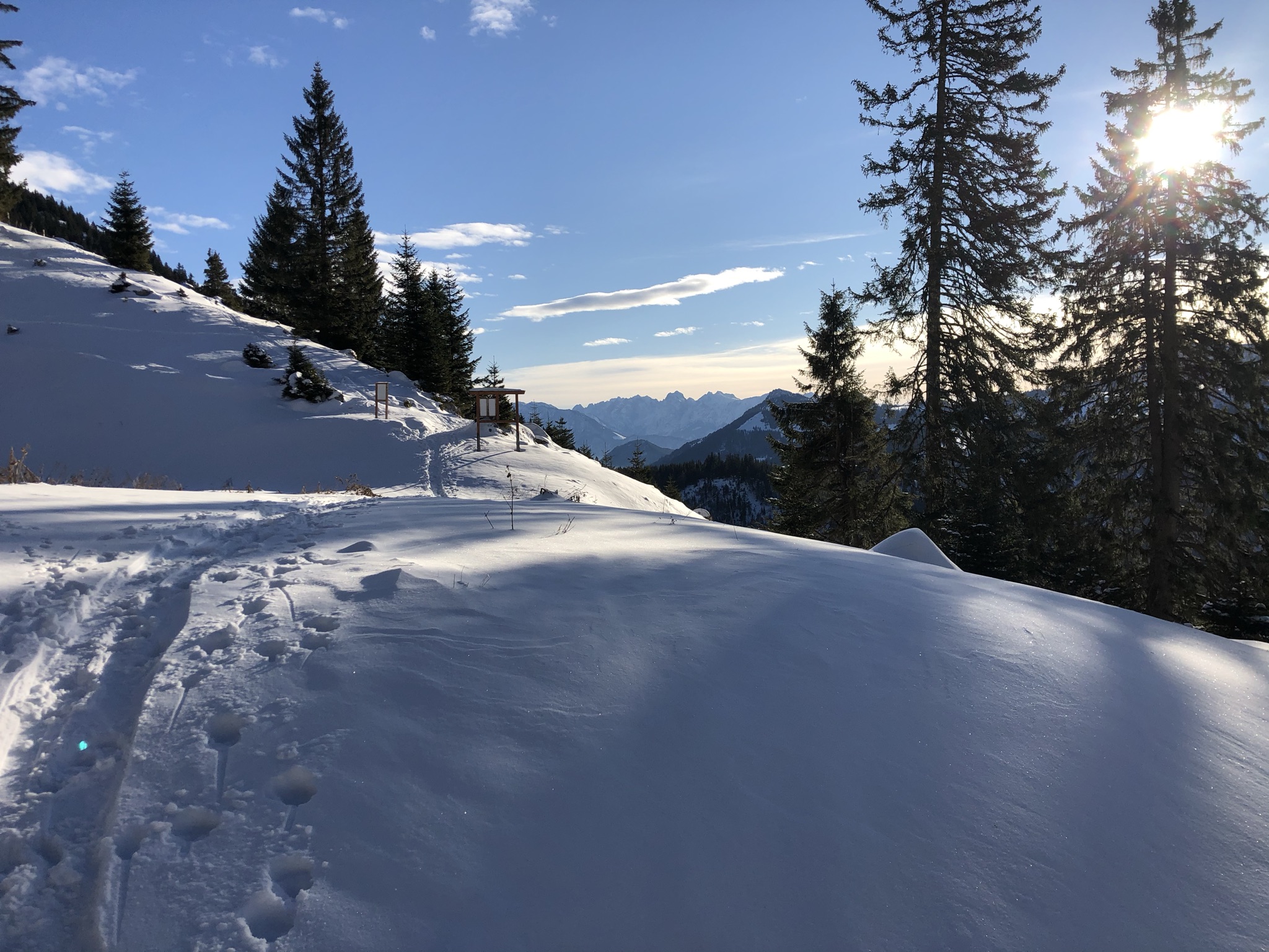 Winter sports enthusiasts enjoying a day on the snowy slopes of Wendelstein mountain in Upper Bavaria, Germany, with a charming challet nestled among the frosty landscape.