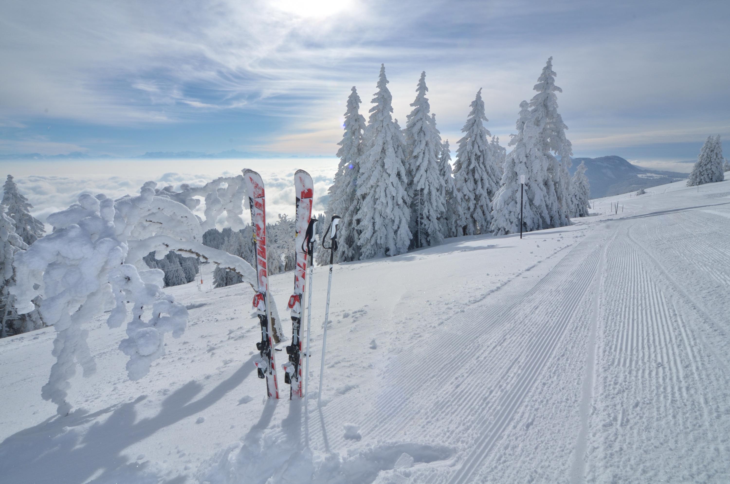A skier enjoying a winter sports scene at the Ste-Croix - Les Rasses ski resort in Switzerland, featuring picturesque winter scenery.