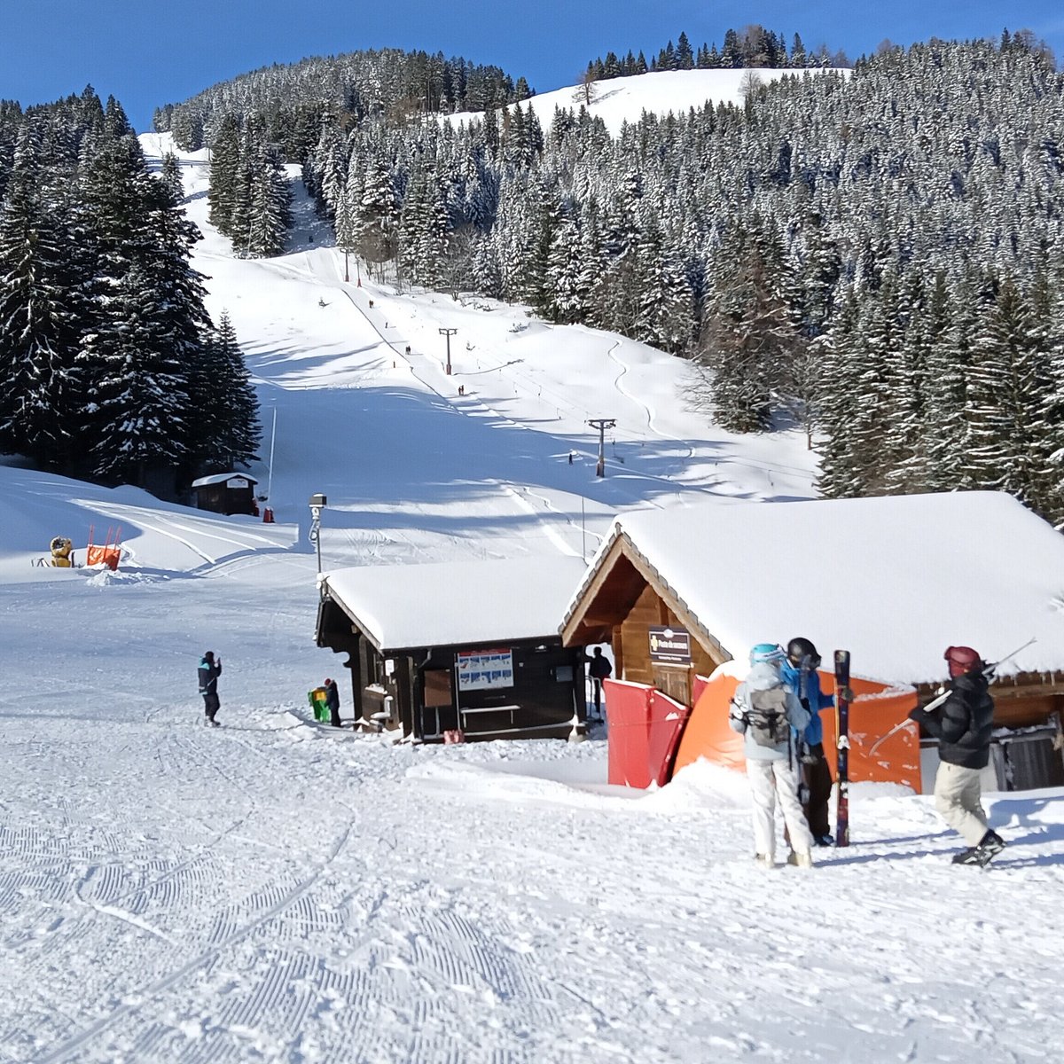 Ste-Croix - Les Rasses in Switzerland - a group of people skiing down a snowy slope.