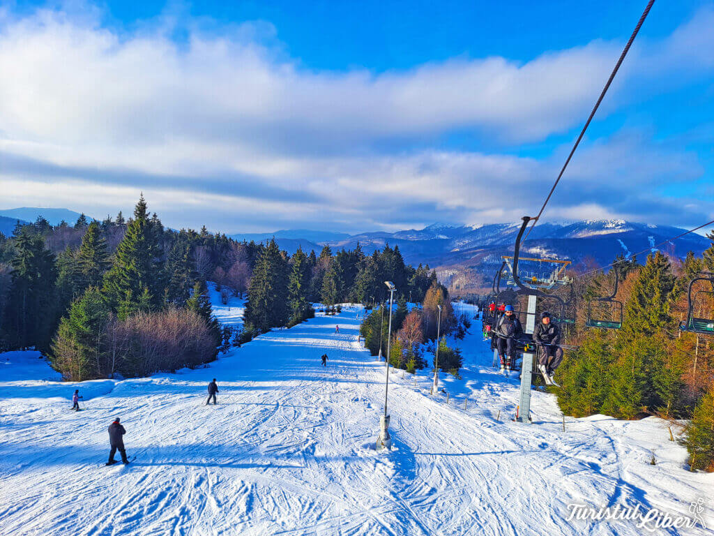 Superski Roata Cavnic in Romania - a ski lift going down a snowy slope.