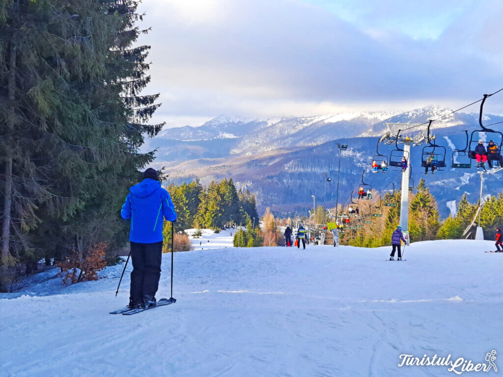 Superski Roata Cavnic in Romania - a group of people skiing down a snowy slope.