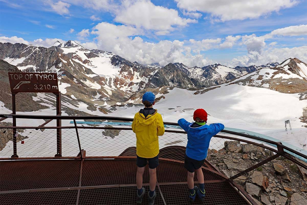 Stubai Glacier in Austria - two children looking out over a mountain range.