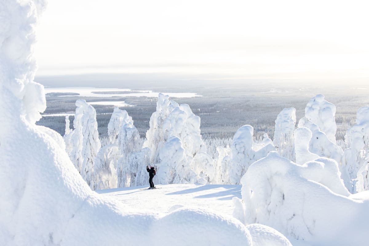 Vuokatti in Finland - a person standing on top of a snow covered mountain.