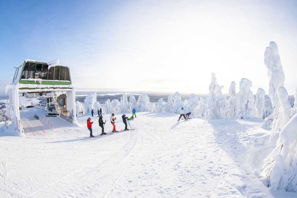 Winter sports scene at Vuokatti in Kainuu Sotkamo East Finland showing a bustling winter sports centre amidst stunning snowy scenery at a ski resort.