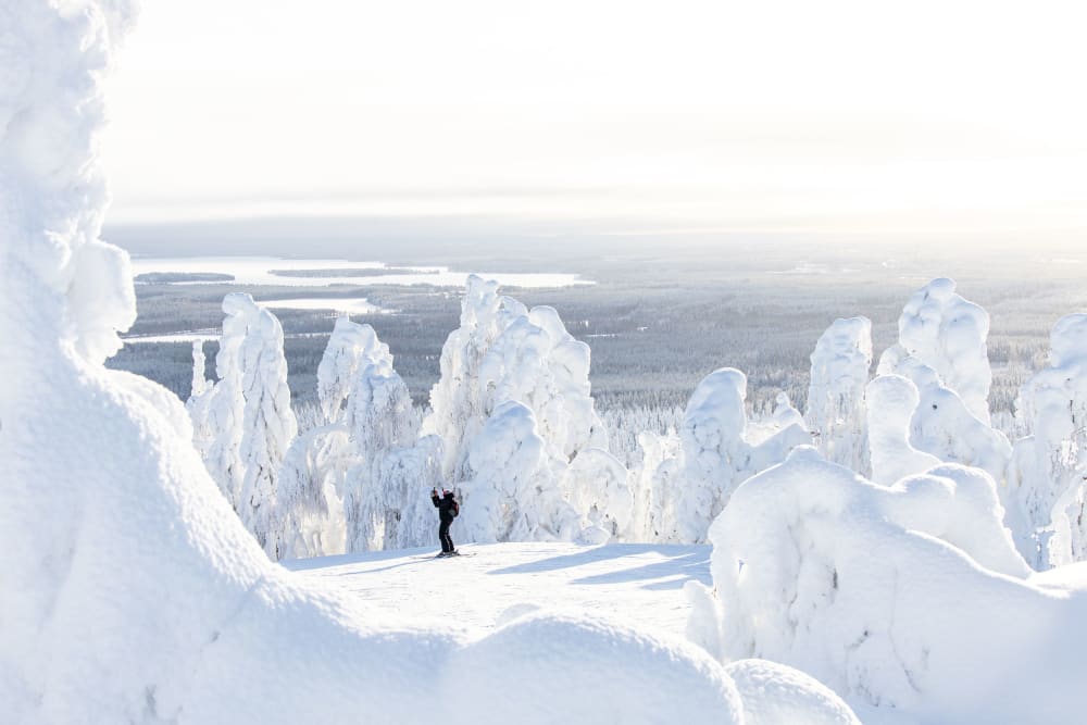 Winter sports scene in Vuokatti, Finland, featuring stunning winter scenery complete with a ski resort and chalet, set against a backdrop of pristine, snowy landscapes.