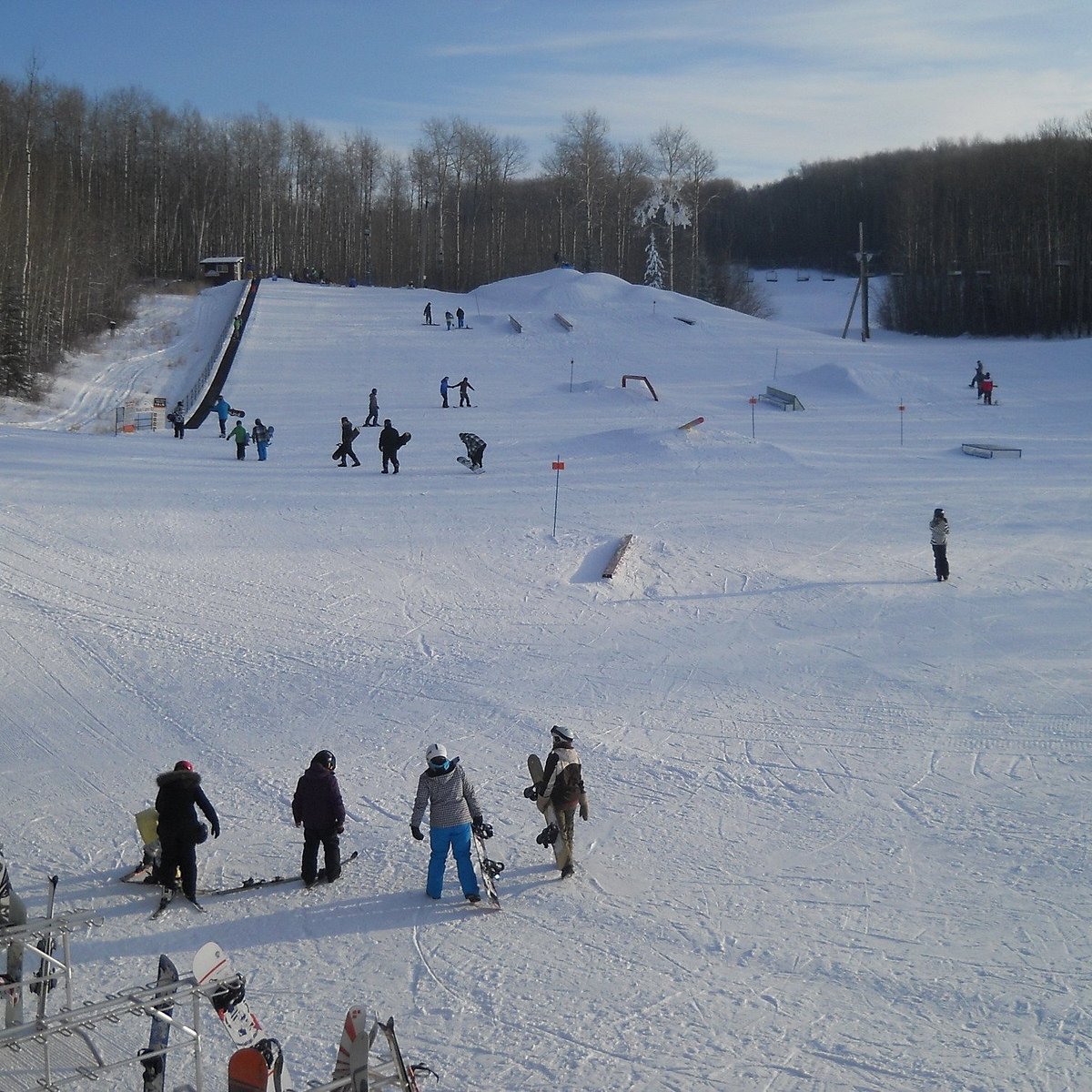 Kinosoo Ridge in Canada - a group of people skiing down a snowy hill.