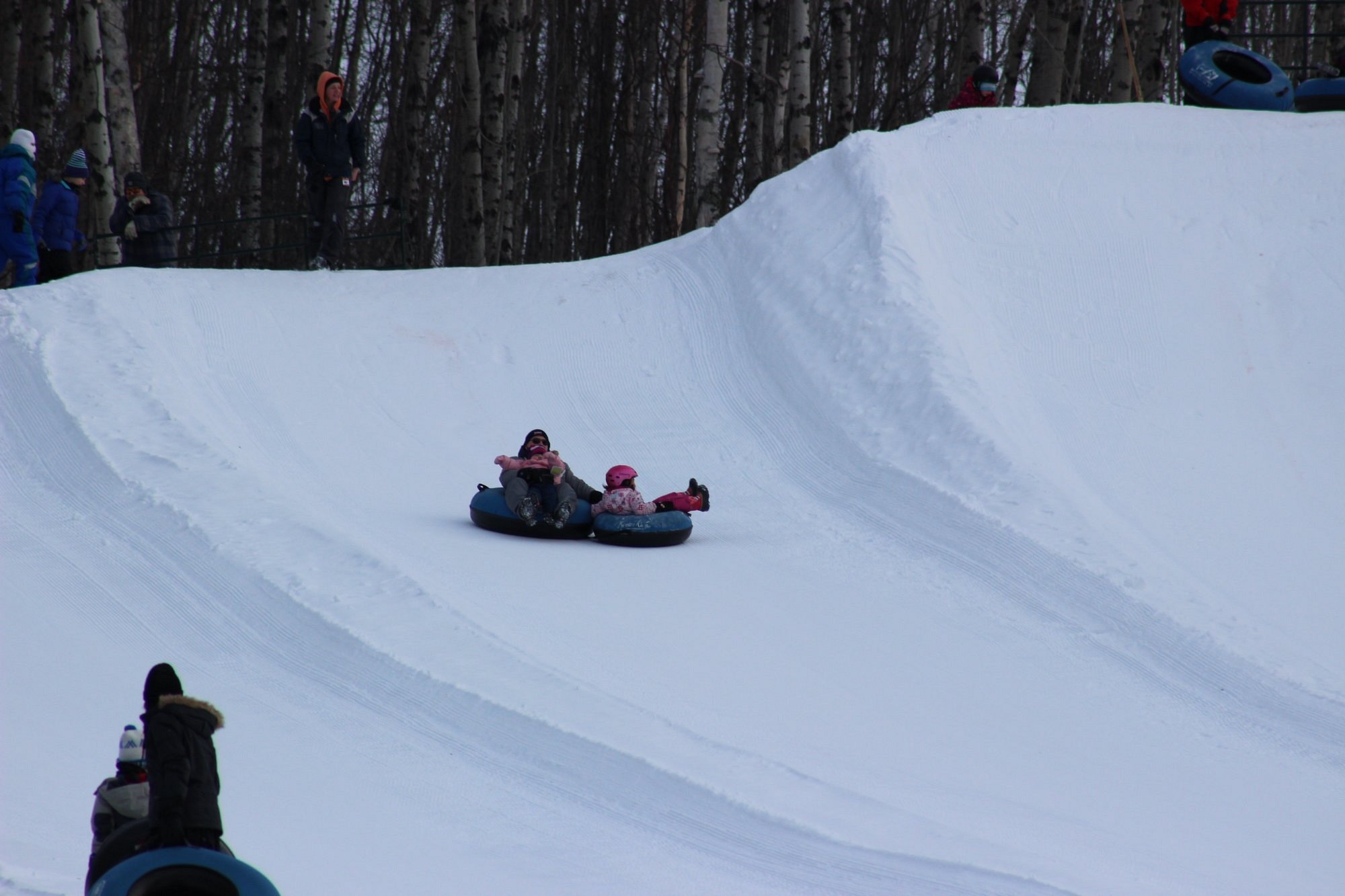 A snowmobile at Kinosoo Ridge, a popular winter sports scene in Cold Lake, Alberta, Canada featuring a ski resort and chalet.