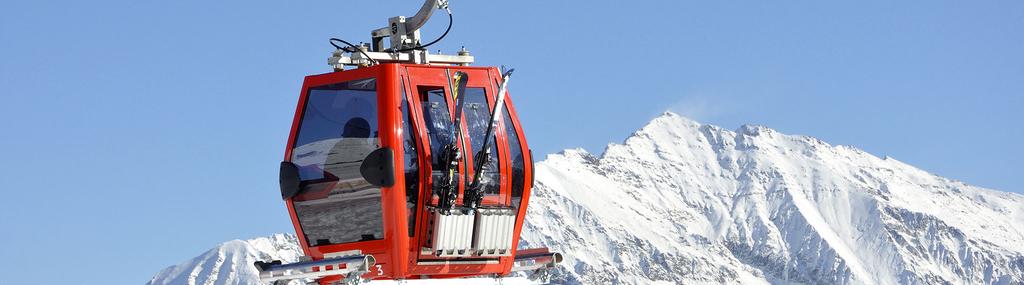 View of Mottarone in Italy featuring a ski lift prominently. There is a challet in the scene and a hint of a ski resort. A skier and a snowmobile are also subtly present.