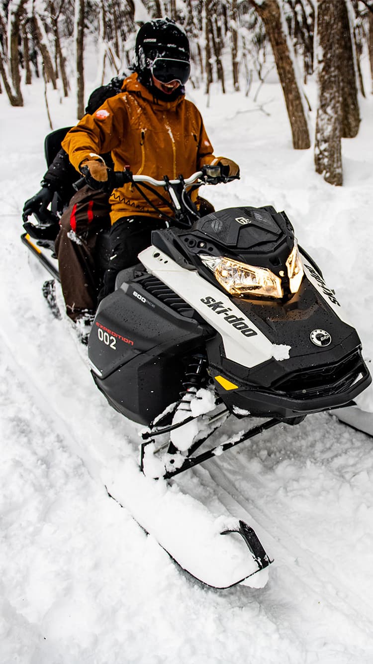 Jiigatake in Japan - a person riding a snowmobile in the snow.