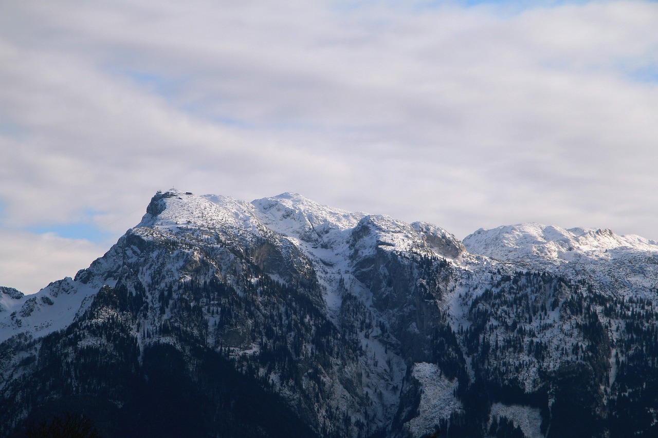 Unterberg in Austria - a large mountain covered in snow under a blue sky.