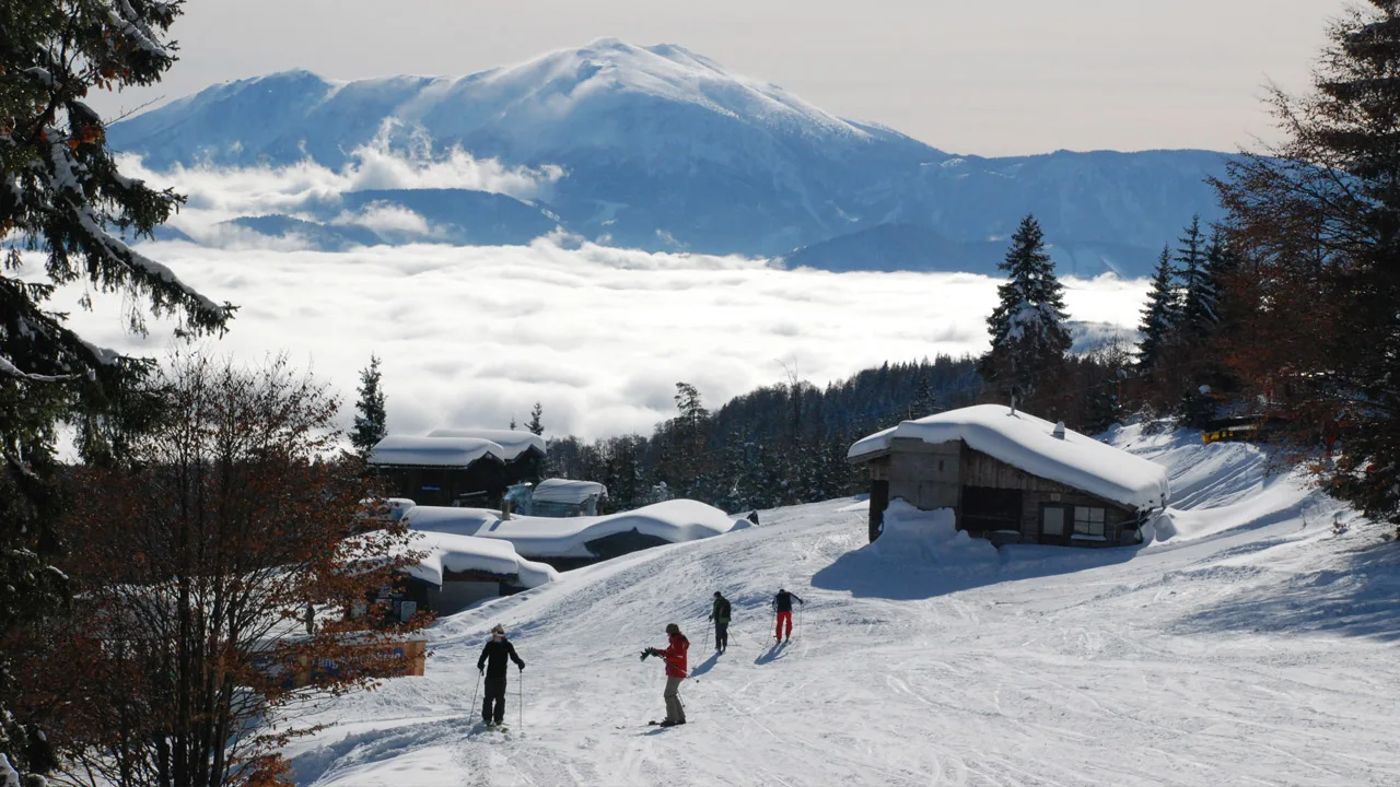 Unterberg in Austria - a group of people skiing down a snowy slope.