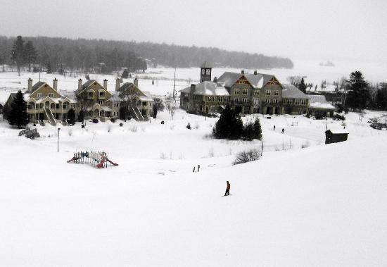 A bustling ski resort at Calabogie Peaks, Ontario with people indulging in winter sports. A charming chalet in the backdrop adds to the scenic winter fervor.