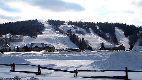 Calabogie Peaks in Canada - a snow covered field with a mountain in the background.