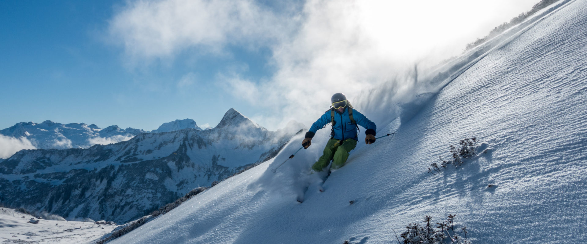 Seilbahnen Sonntag in Austria - a person skiing down a snowy slope in the mountains.