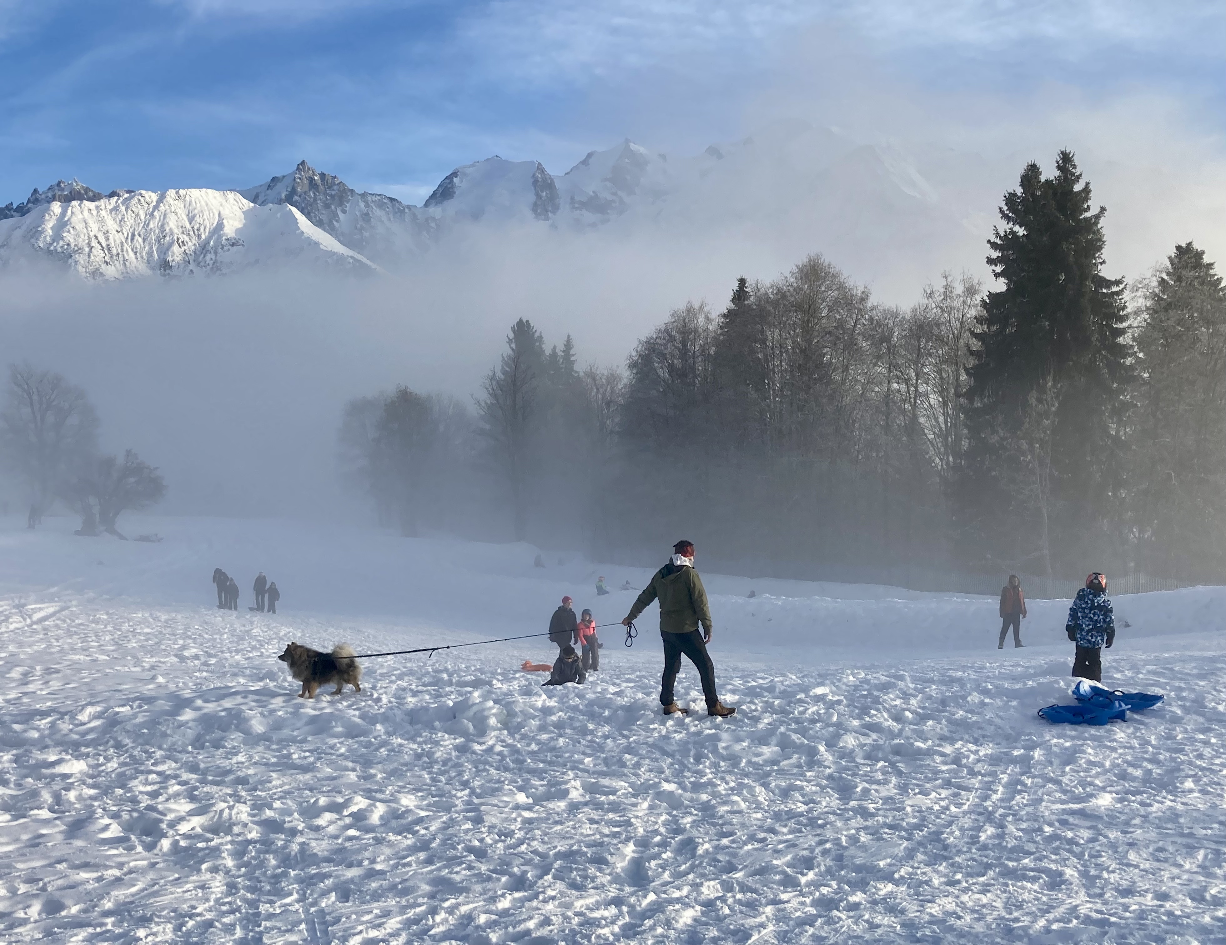 Winter sports scene at Passy Plaine-Joux in Savoie Mont Blanc, France showing a bustling sports centre with skiers.