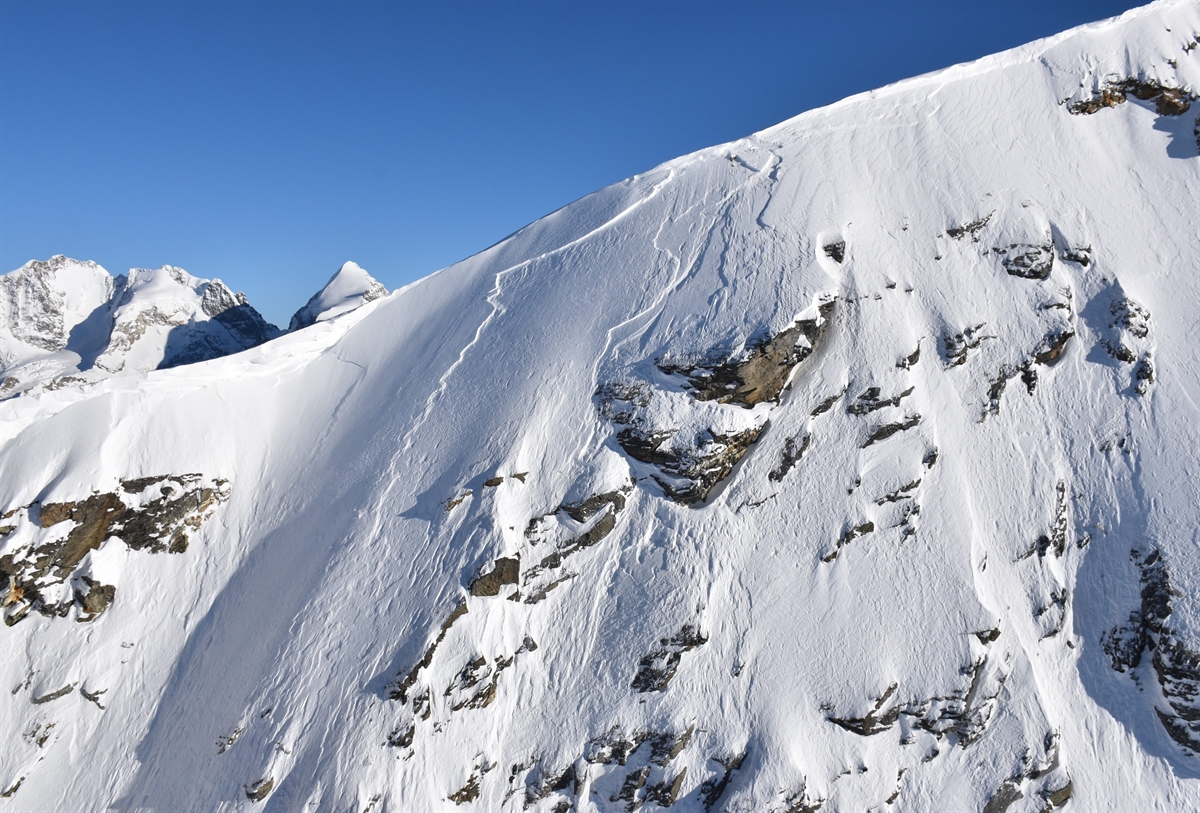 Corvatsch | Furtschellas in Switzerland - a person on a snowboard on a snowy mountain.