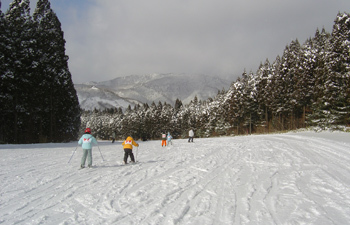 A winter sports scene at Taiheizan Opas in Akita Japan featuring a ski resort and a quaint challet surrounded by a stunning winter landscape.