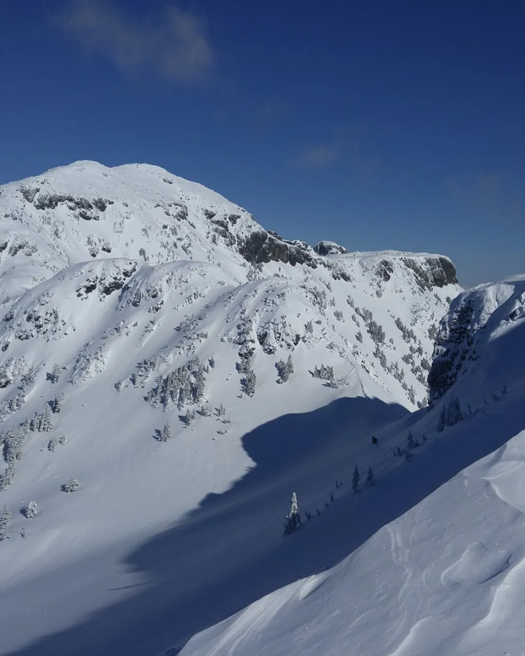 Mount Cain Alpine Park in Canada - a mountain covered in snow with a blue sky.