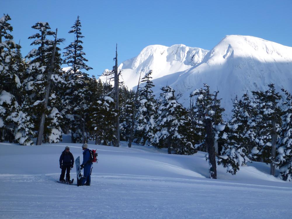 Winter sports scene at Mount Cain Alpine Park on Vancouver Island, featuring a mountain, ski resort, and a family skiing in beautiful winter scenery.