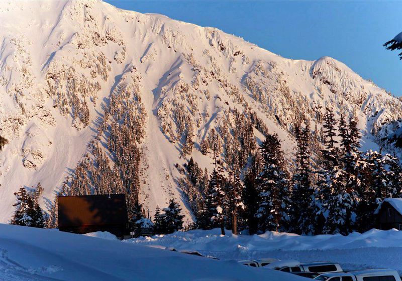 Scenic view of Mount Cain Alpine Park in Vancouver Island, Canada, featuring a mountain hut, a lodge, and the landscape of a ski resort at the heart of a bustling winter sports scene.