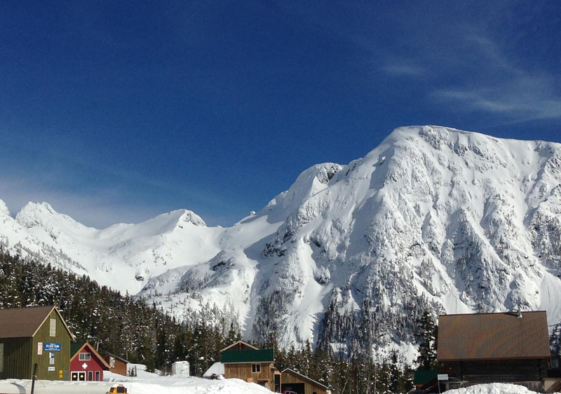 Picture of the breathtaking Mount Cain Alpine Park on Vancouver Island presenting a serene winter scene with its expansive ski resort set amidst the majestic, snow-covered mountain.