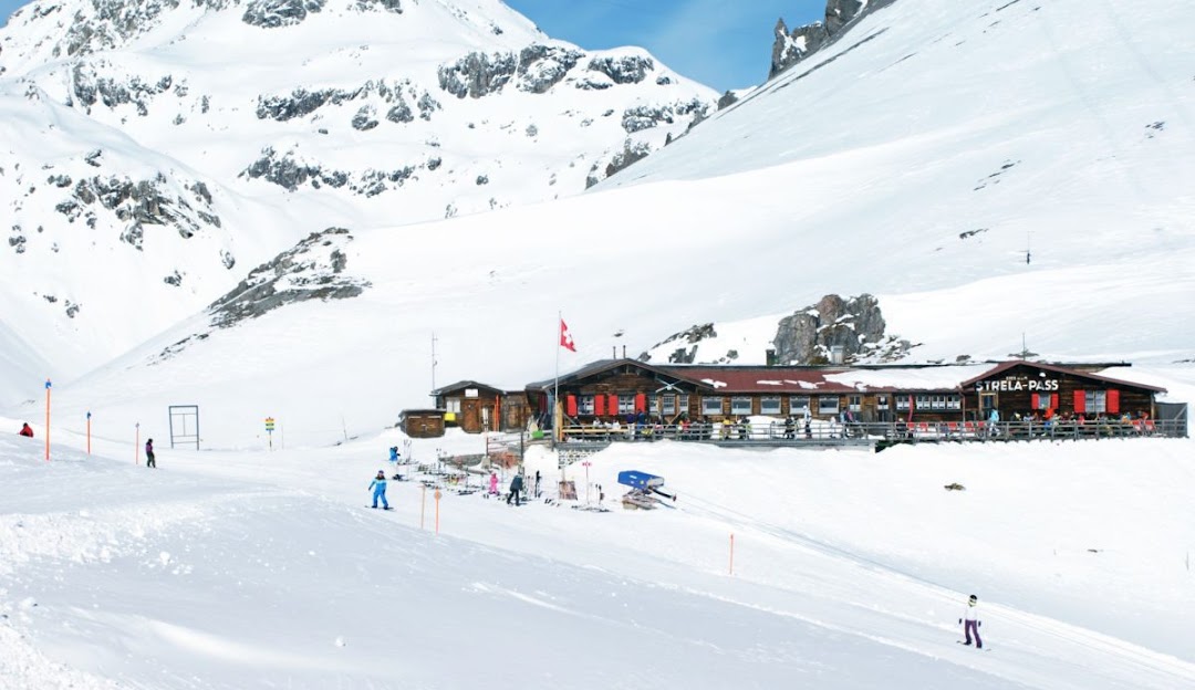 View of SlowMountain Schatzalp-Strela a popular ski resort in Davos Klosters Eastern Switzerland. The image also features a chalet a winter sports centre and a quaint mountain hut amidst a scenic winter sports setting.