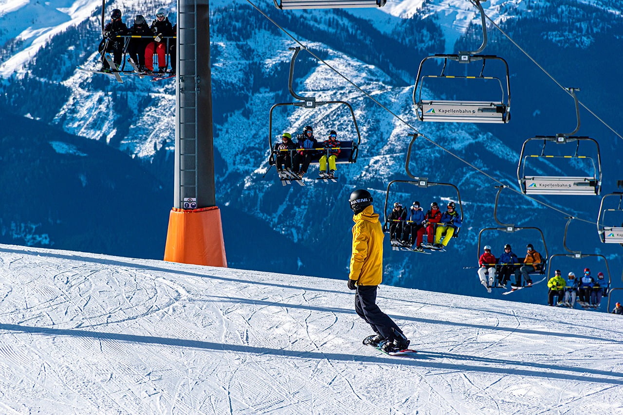 Ski areál Jadrná - Orlické Záhoří in Czech Republic - a man riding a snowboard down a snow covered slope.