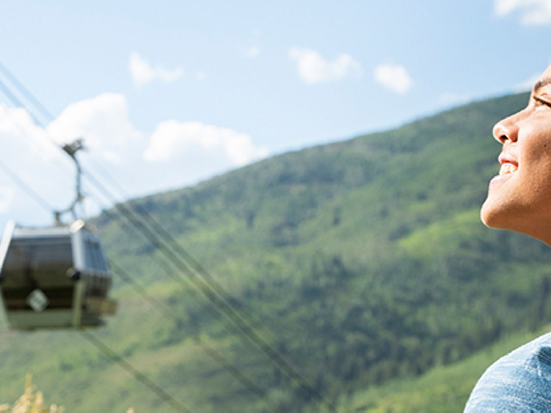 Golden Mountain in China - a woman looking up at a cable car.