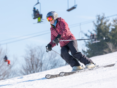 A snowboarder glides down the snowy slopes at Snow Trails, Mansfield, Ohio, embracing the winter season with exhilarating outdoor recreation.