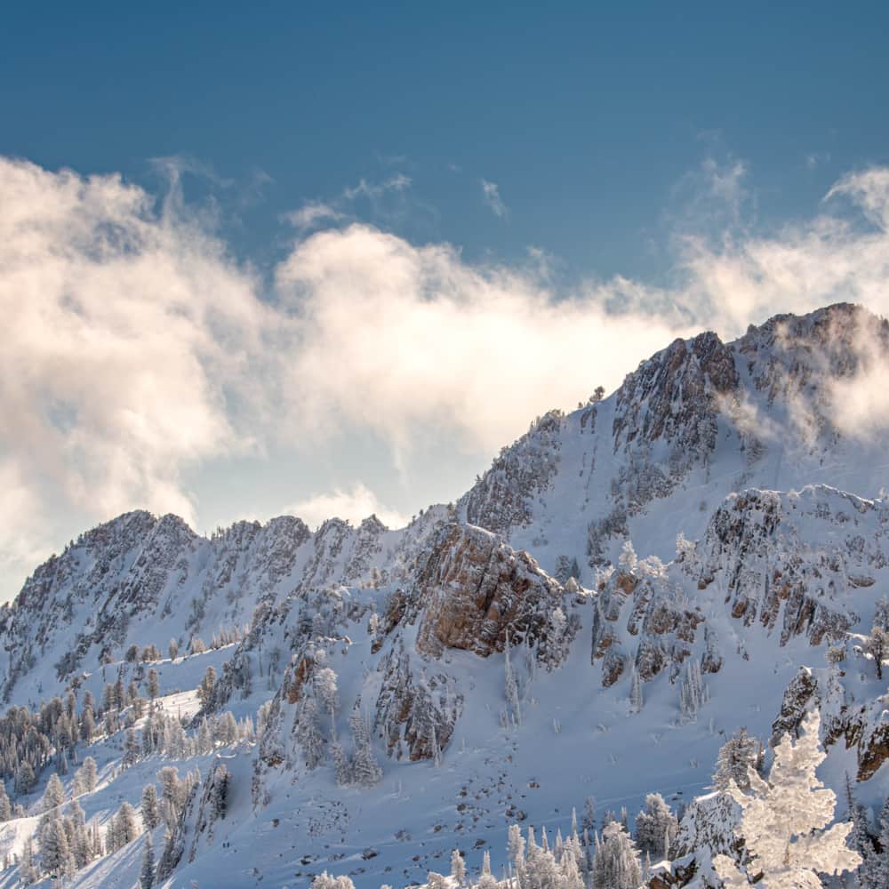 Stunning view of Snowbasin, Utah showcasing a dramatic mountain under a coat of soft white snow. Scene is radiating a wintery ambiance, enticing winter sports enthusiasts.