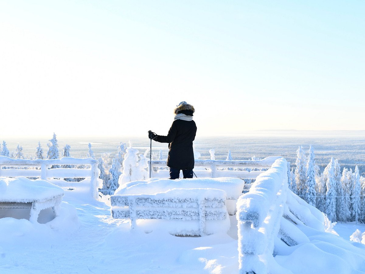 Ukkohalla in Finland - a person standing on top of a snow covered mountain.
