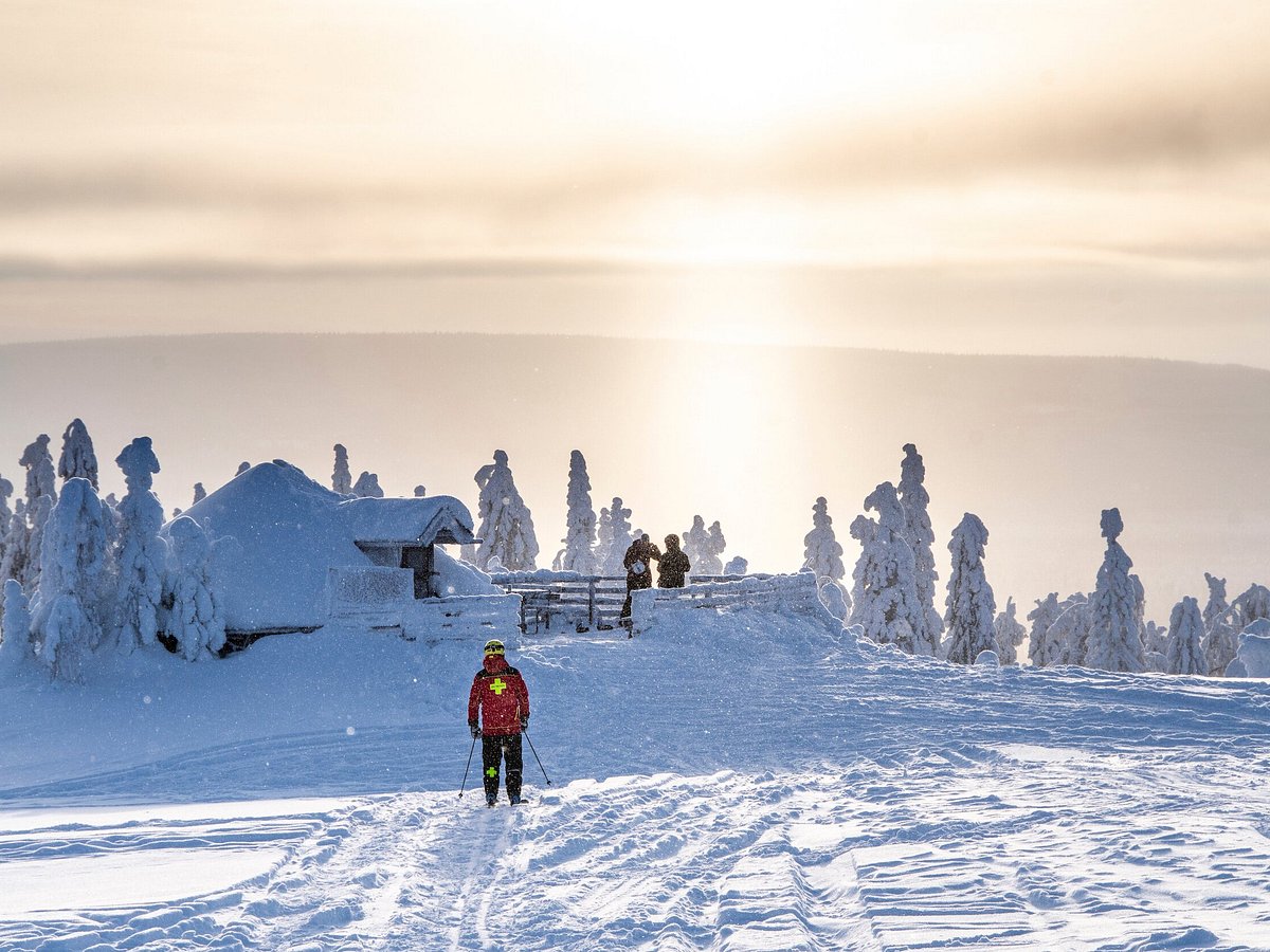 Ukkohalla in Finland - a person walking up a snow covered mountain.