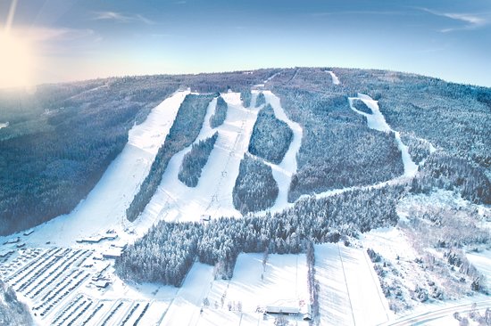 A ski resort in Sunne Rottneros Central Sweden featuring snow-covered slopes a chalet and winter sports enthusiasts enjoying their activities.