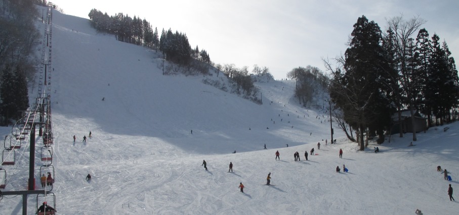 Winter sports enthusiasts enjoying a day of skiing at a resort in Taira, Nanto, Toyama, Japan, complete with well-equipped winter sports centre and cozy chalet.