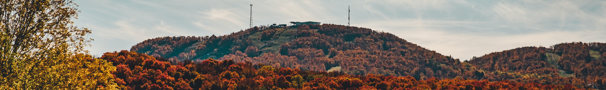 Snow-dusted mountain in Bromont, Quebec hosting a ski resort with a visible ski lift, epitomizing a serene winter sports scene. A mountain bike hints at an active, adventurous lifestyle.