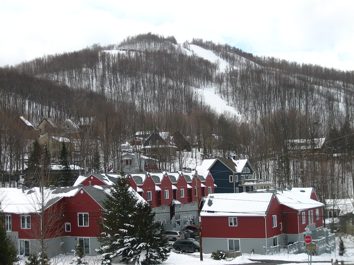Bromont in Canada - a red house with a mountain in the background.