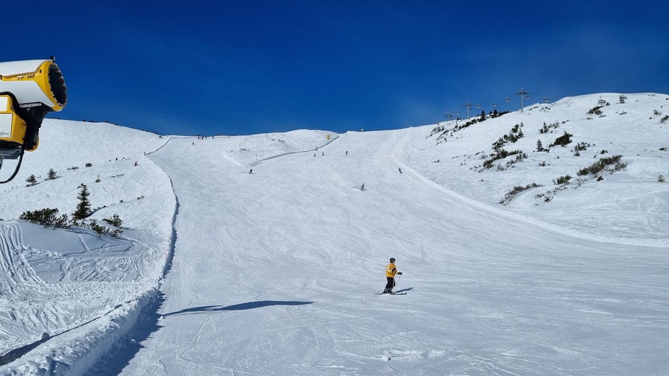 Tauplitz in Austria - a person is skiing down a snowy hill.