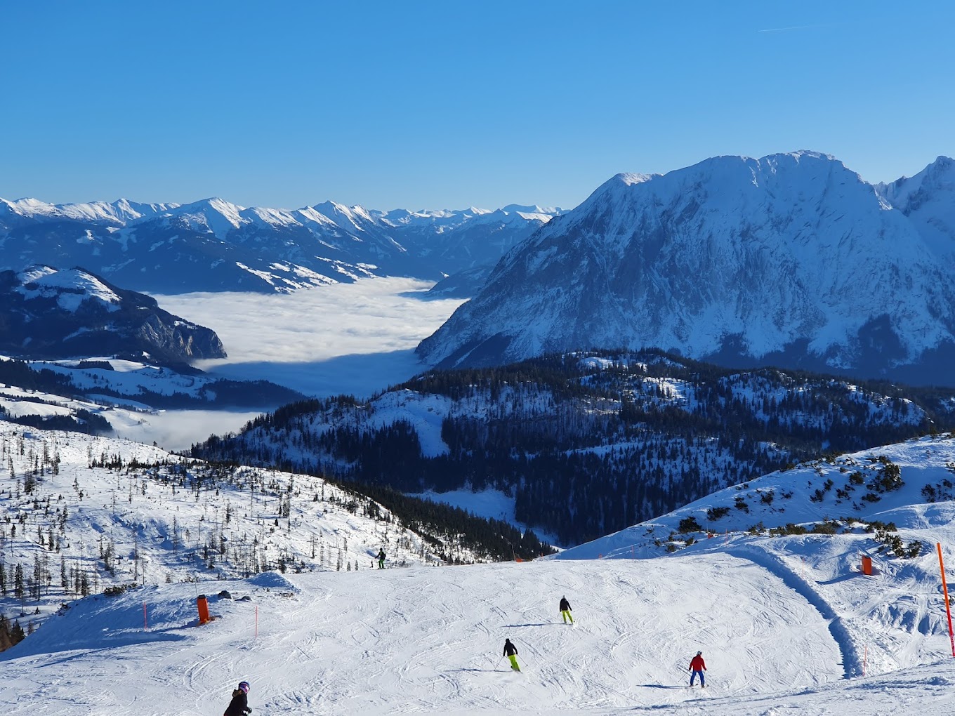 Tauplitz in Austria - a group of people skiing down a snowy slope.