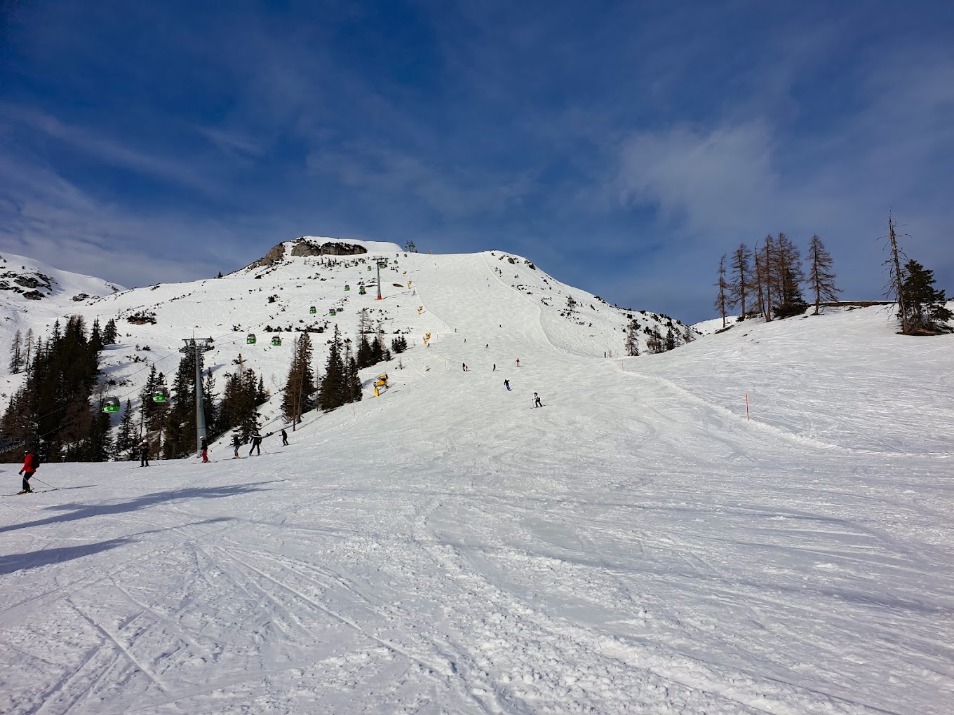 Tauplitz in Austria - a group of people skiing down a snowy slope.