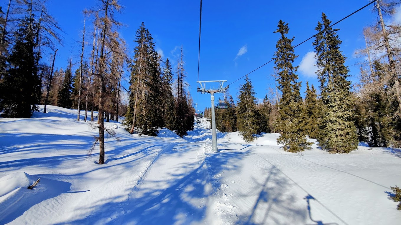 Tauplitz in Austria - a ski lift going down a snowy slope.