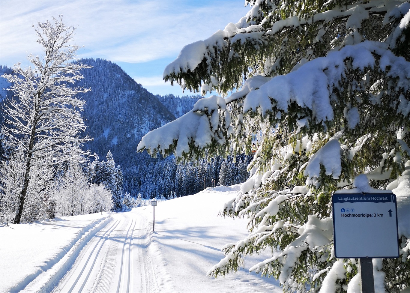 Ski & Bike park Königsberg in Austria - a snowy road with a sign in the middle.
