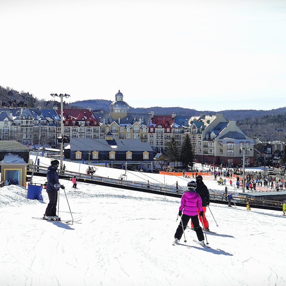 Mont Habitant in Canada - a group of people skiing down a hill.