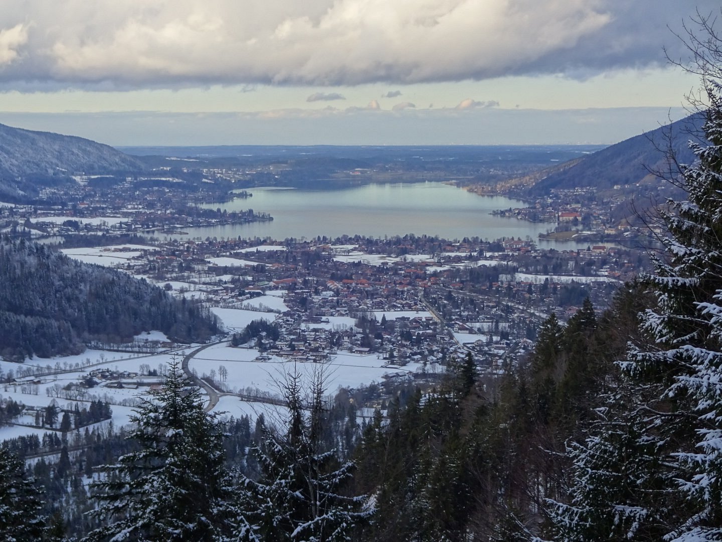 Winter sports enthusiasts enjoying a day on the snowy slopes of Wallberg, Upper Bavaria, Germany. Charming chalets and crisp winter scenery form the stunning backdrop in this ski resort.