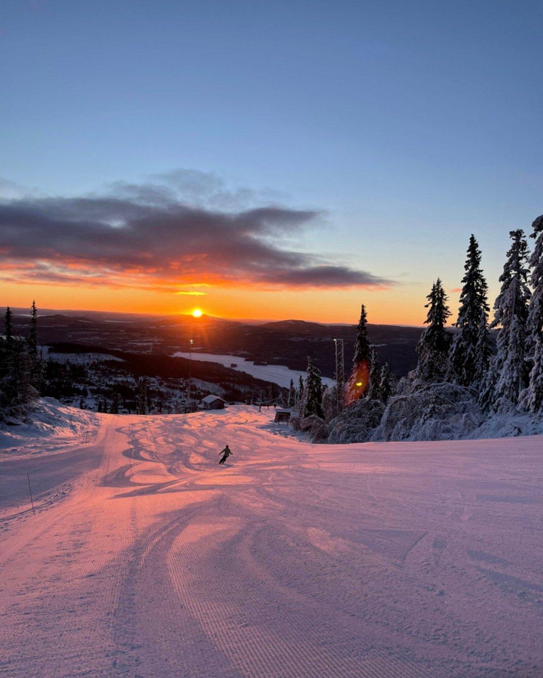 Winter sports scene in Tännäskröket, Jämtland, Sweden showcasing a snowy ski resort with a charming challet nestled in the breath-taking winter scenery.
