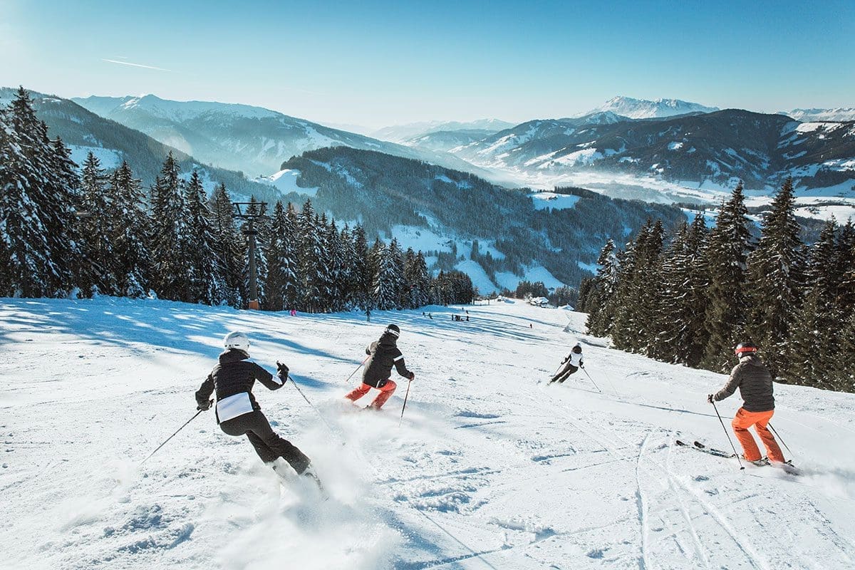 Radstadt Altenmarkt in Austria - a group of people skiing down a mountain.