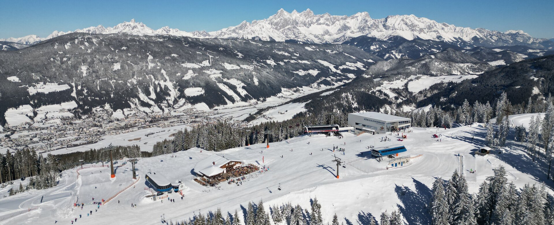 Radstadt Altenmarkt in Austria - a ski slope with snow covered mountains in the background.