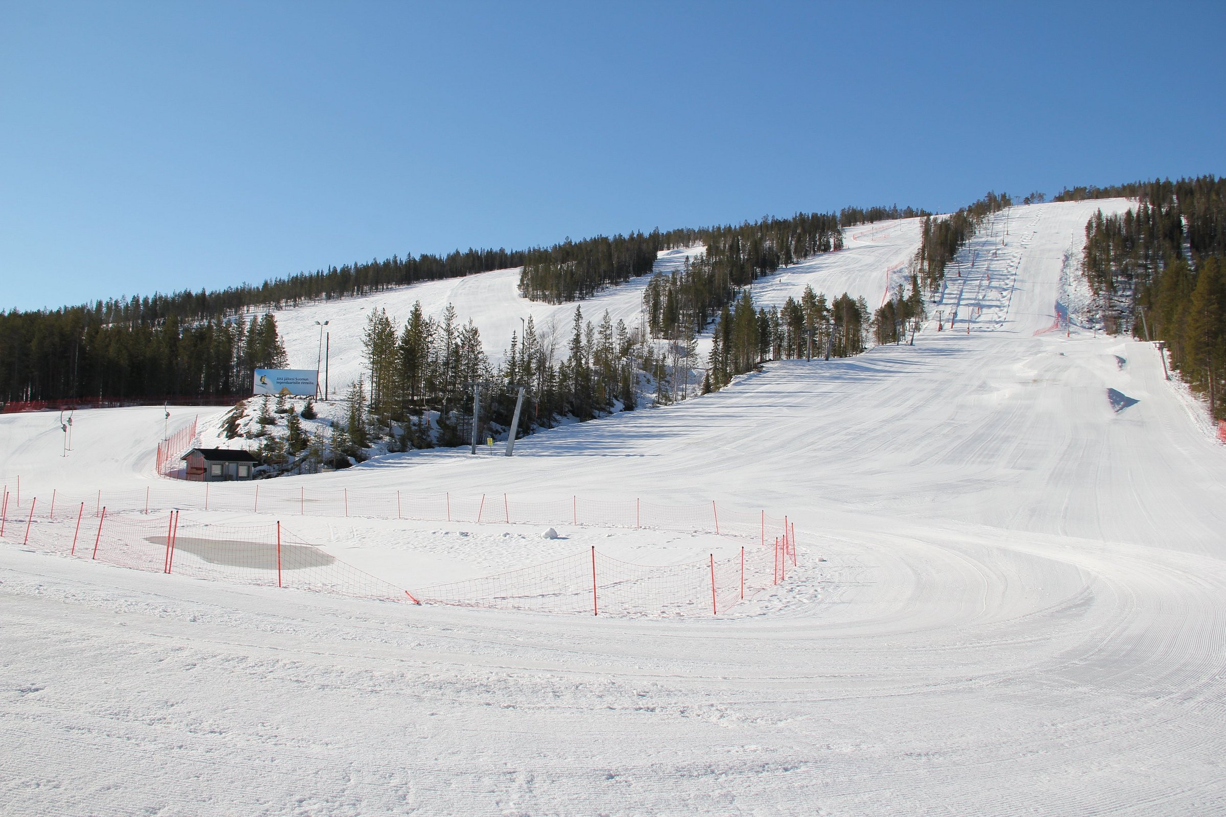 A captivating winter scene at Suomutunturi in Lapland Northern Finland showcasing a bustling ski resort featuring ski lifts and snow-covered slopes buzzing with winter sports activities.