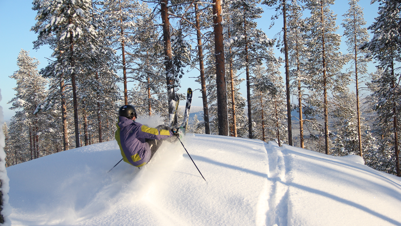 Suomutunturi in Finland - a person skiing down a hill in the snow.