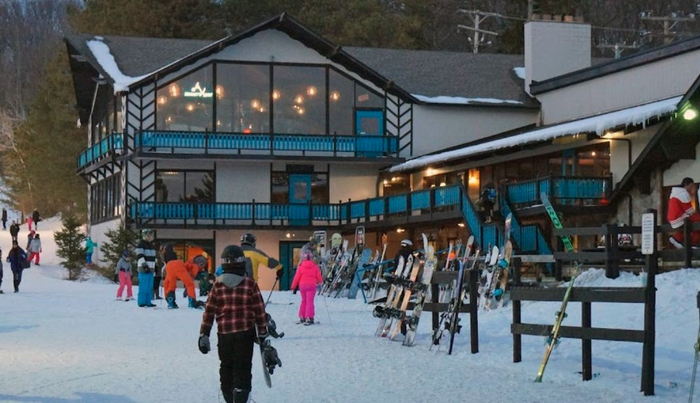 View of Alpine Valley Ski Resort in White Lake, Michigan, showcasing a winter sports scene with active ski lifts amidst stunning winter scenery.