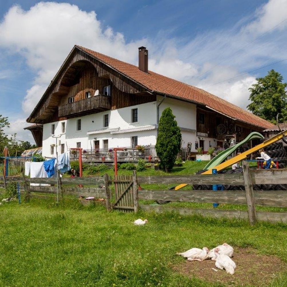 Tramelan in Switzerland - a house with a playground in front of it.